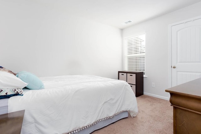 bedroom with light colored carpet