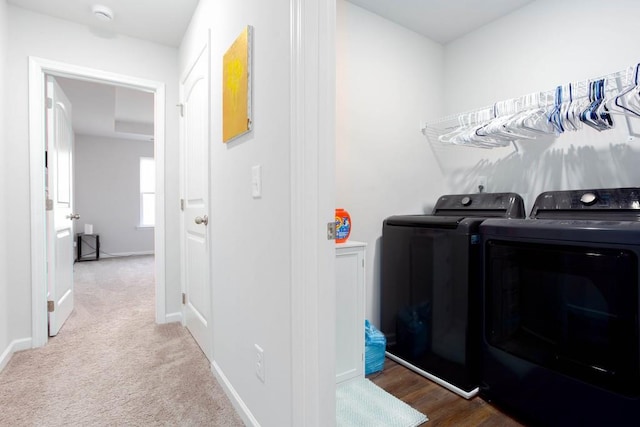 laundry area featuring washer and clothes dryer and carpet