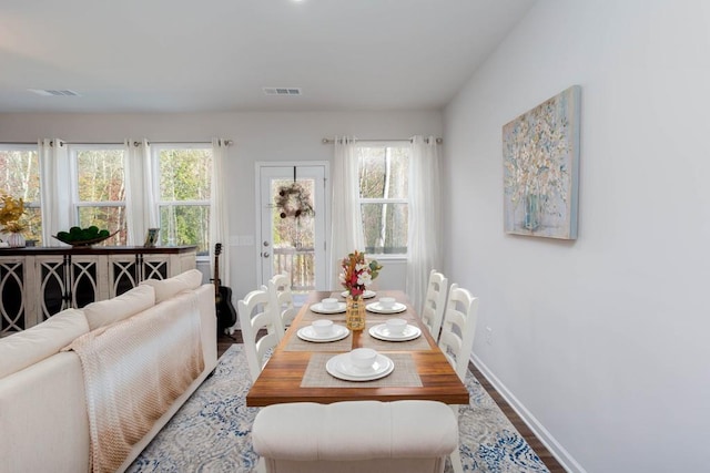 dining space with plenty of natural light and hardwood / wood-style floors