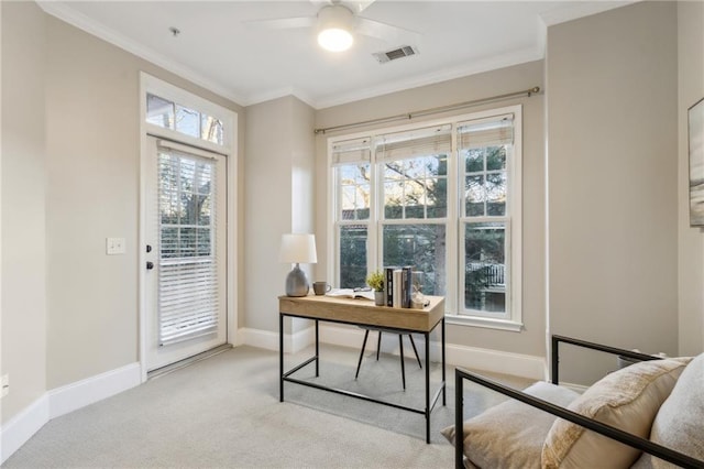 home office with light carpet, baseboards, visible vents, a ceiling fan, and crown molding