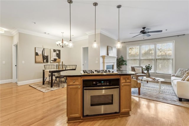 kitchen with dark countertops, light wood-style flooring, open floor plan, stainless steel oven, and white gas cooktop