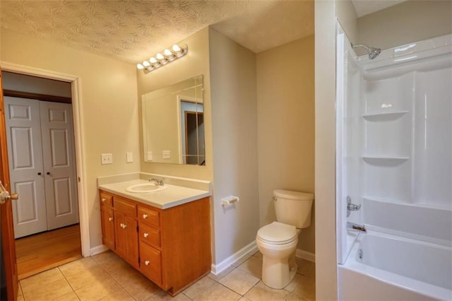 full bathroom featuring toilet, tile patterned flooring, washtub / shower combination, and vanity