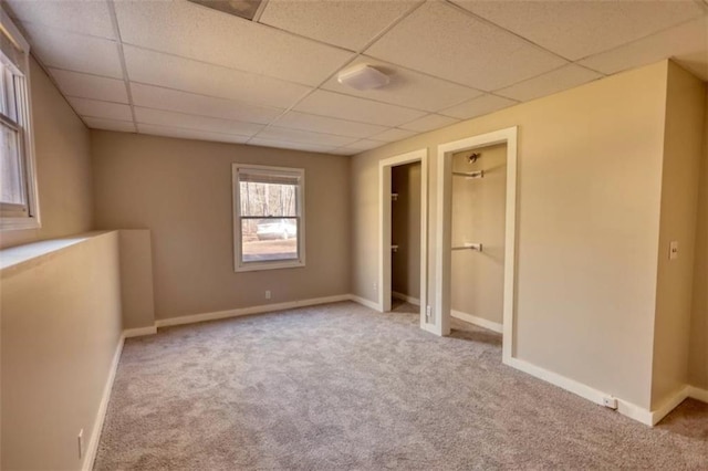 carpeted spare room featuring a paneled ceiling