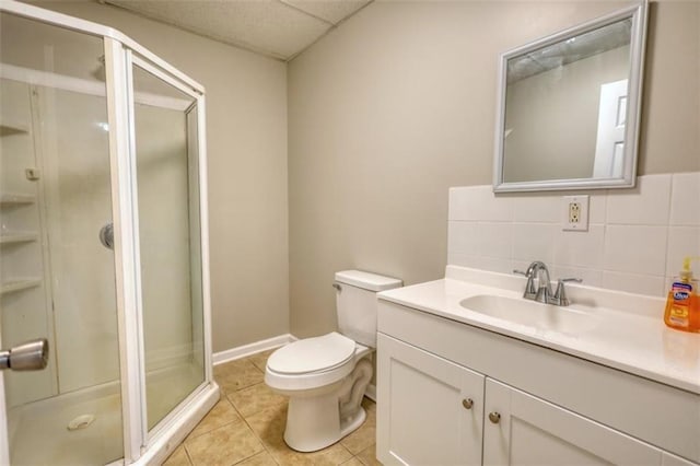 bathroom with toilet, a shower with door, tasteful backsplash, tile patterned flooring, and vanity