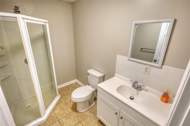 bathroom featuring tasteful backsplash, vanity, toilet, tile patterned floors, and a shower with shower door