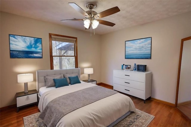 bedroom with ceiling fan and light hardwood / wood-style floors