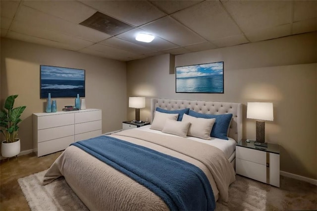 bedroom featuring a paneled ceiling and carpet