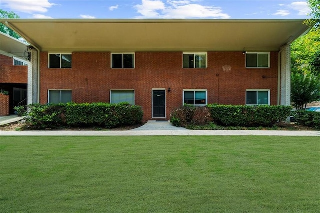 1822 N Rock Springs Rd NE Unit 24, Atlanta, GA 30324 - view of front of property featuring a front yard and brick siding