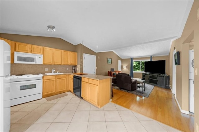 1822 N Rock Springs Rd NE Unit 24, Atlanta, GA 30324 - kitchen featuring white appliances, light brown cabinets, open floor plan, lofted ceiling, and a peninsula