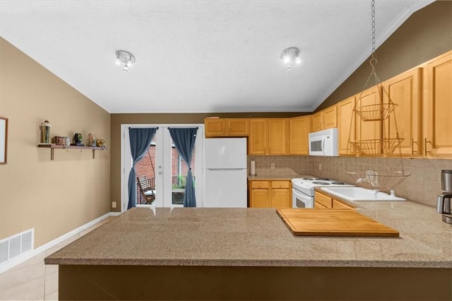 1822 N Rock Springs Rd NE Unit 24, Atlanta, GA 30324 - kitchen with white appliances, lofted ceiling, crown molding, tasteful backsplash, and a peninsula