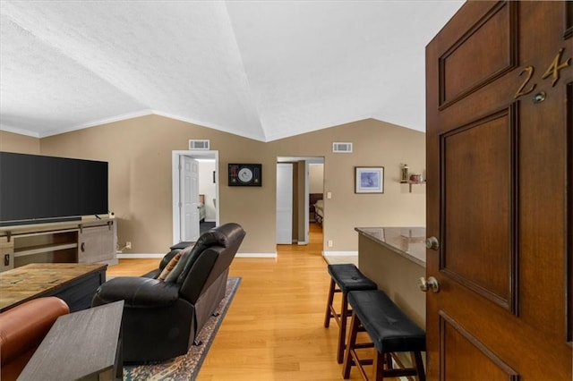 1822 N Rock Springs Rd NE Unit 24, Atlanta, GA 30324 - living area with light wood-type flooring, vaulted ceiling, and ornamental molding