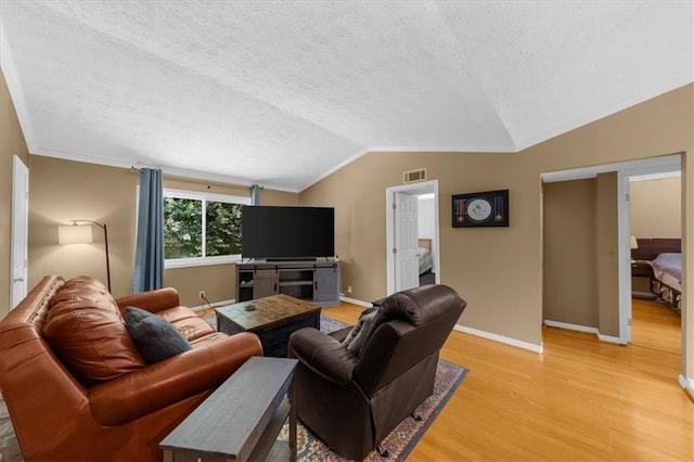 1822 N Rock Springs Rd NE Unit 24, Atlanta, GA 30324 - living area featuring lofted ceiling, light wood-style flooring, a textured ceiling, and ornamental molding