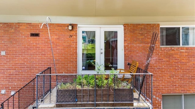 1822 N Rock Springs Rd NE Unit 24, Atlanta, GA 30324 - entrance to property featuring french doors, brick siding, and a balcony