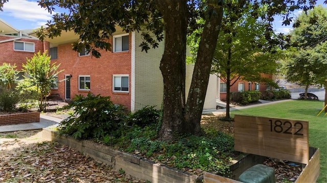 1822 N Rock Springs Rd NE Unit 24, Atlanta, GA 30324 - view of home's exterior featuring brick siding and a lawn