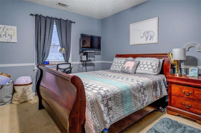 carpeted bedroom featuring a textured ceiling