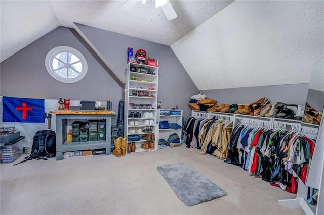 walk in closet featuring lofted ceiling, carpet floors, and ceiling fan