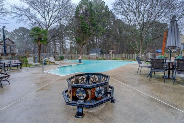 view of swimming pool featuring a fire pit and a patio area