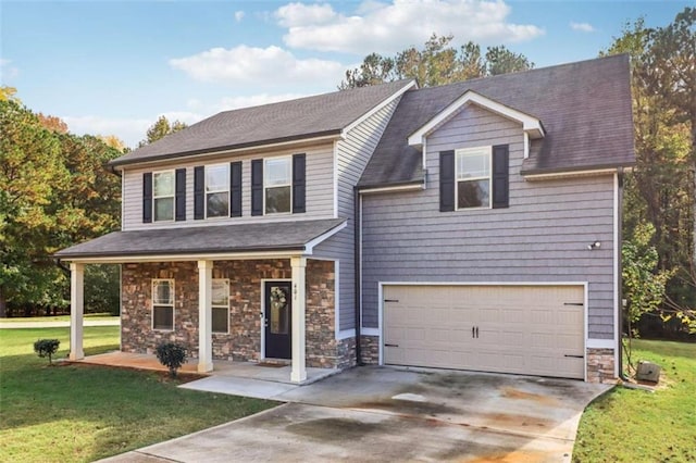 view of front of property with a front yard and a garage