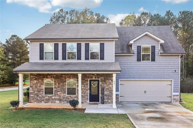 view of front facade featuring a front yard, a garage, and covered porch