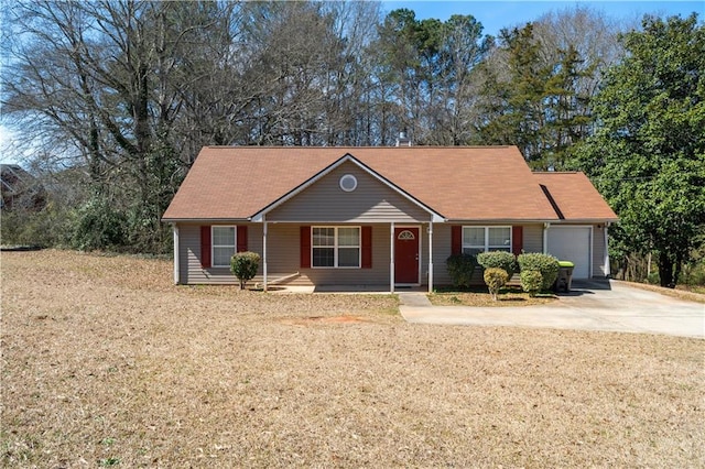 single story home featuring a front yard, concrete driveway, and an attached garage