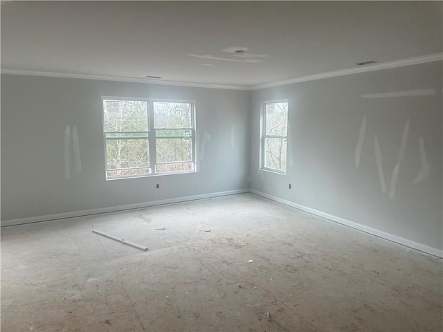 empty room with ornamental molding, visible vents, and baseboards