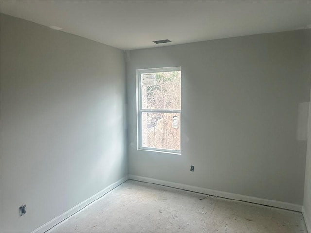 unfurnished room with visible vents and baseboards