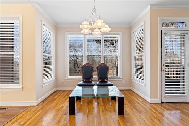 dining space with hardwood / wood-style floors, a notable chandelier, and ornamental molding