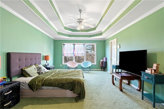 carpeted bedroom featuring ceiling fan, crown molding, and a tray ceiling