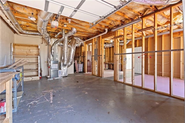 basement featuring heating unit and electric panel