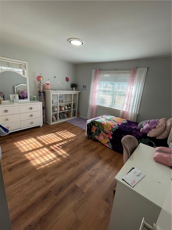 bedroom with dark wood-style floors