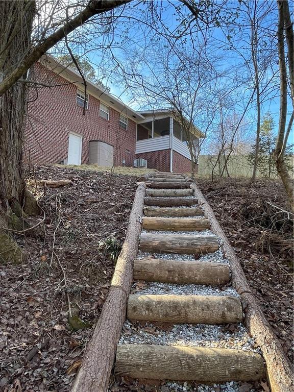 view of yard with a sunroom and stairway