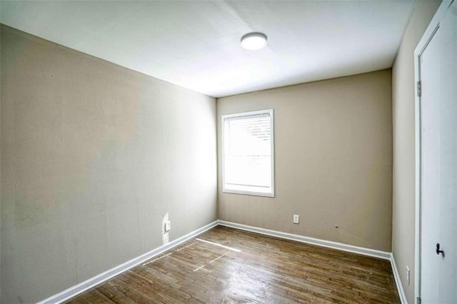 empty room with dark hardwood / wood-style floors