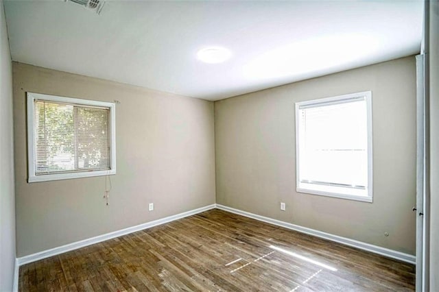 unfurnished room with hardwood / wood-style floors