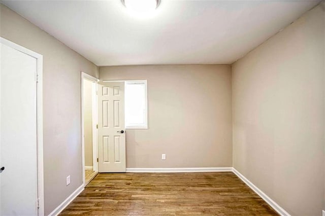 empty room with hardwood / wood-style flooring