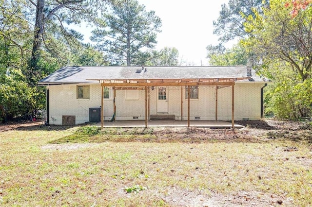 back of house featuring central air condition unit, a patio area, and a lawn