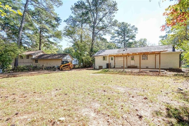 back of property with a yard and a patio