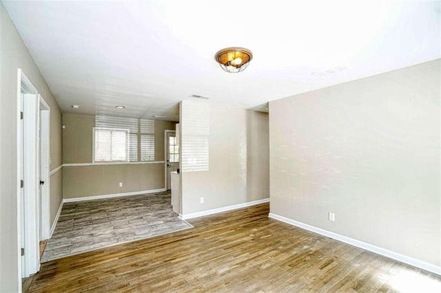 empty room with hardwood / wood-style flooring