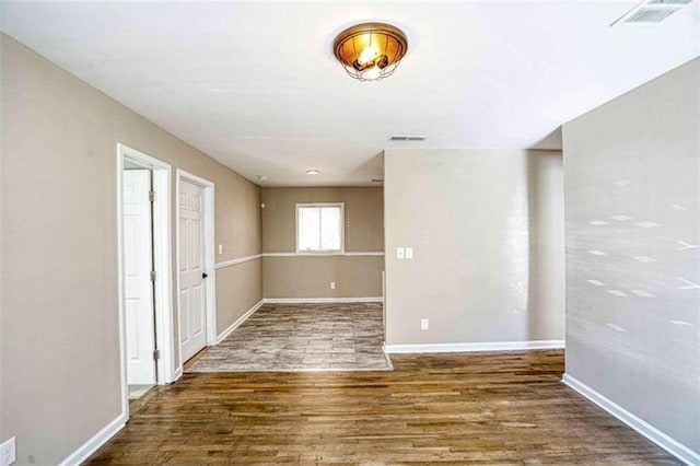 spare room featuring wood-type flooring