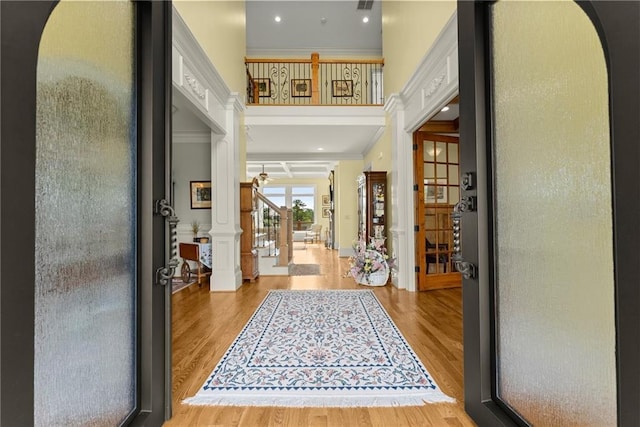 4645 Manor Dr, Gainesville, GA 30506 - foyer entrance with ornamental molding, wood finished floors, arched walkways, recessed lighting, and stairway