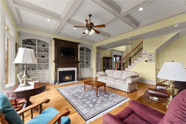 4645 Manor Dr, Gainesville, GA 30506 - living room featuring ceiling fan, wood finished floors, beamed ceiling, a fireplace with flush hearth, and stairs