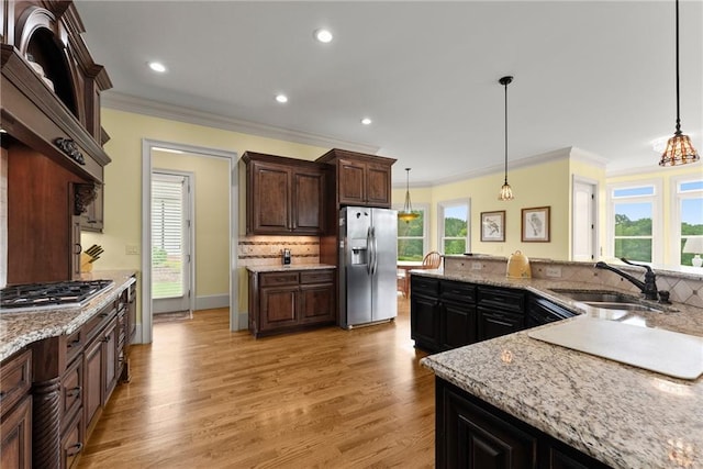 4645 Manor Dr, Gainesville, GA 30506 - kitchen featuring appliances with stainless steel finishes, a sink, crown molding, tasteful backsplash, and light wood-type flooring