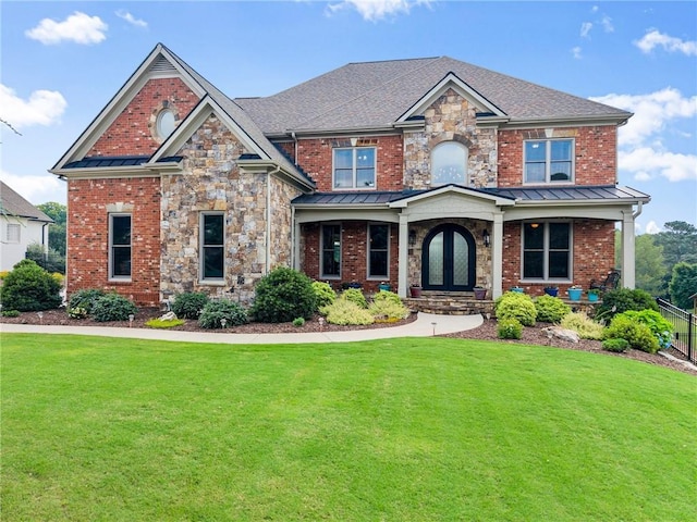 4645 Manor Dr, Gainesville, GA 30506 - craftsman inspired home featuring a front lawn, a standing seam roof, brick siding, and stone siding