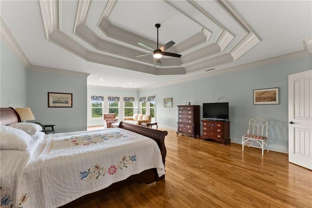 4645 Manor Dr, Gainesville, GA 30506 - bedroom with crown molding, wood finished floors, baseboards, a ceiling fan, and a raised ceiling