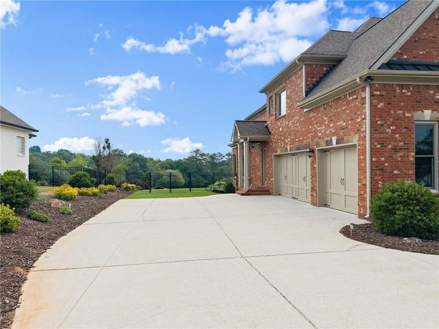 4645 Manor Dr, Gainesville, GA 30506 - view of side of property with driveway, brick siding, and roof with shingles