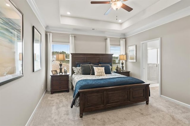 bedroom featuring light carpet, baseboards, a raised ceiling, recessed lighting, and connected bathroom