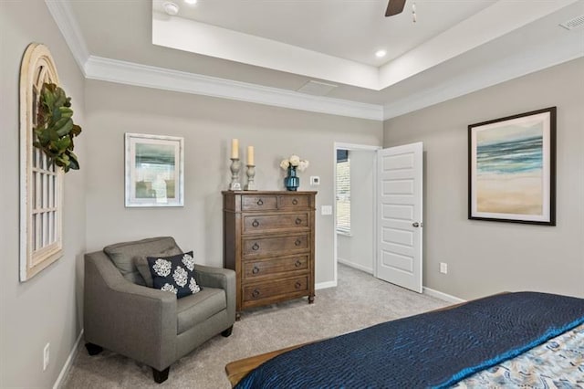 bedroom featuring a tray ceiling, carpet floors, ornamental molding, baseboards, and a ceiling fan
