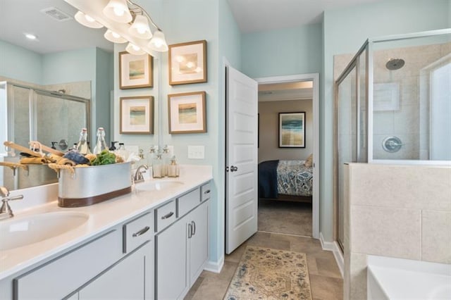 bathroom featuring a stall shower, double vanity, and a tub to relax in