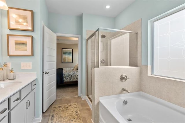 full bathroom with a shower stall, a bath, vanity, and ensuite bathroom