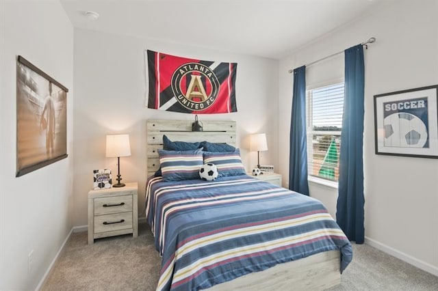 bedroom with carpet floors and baseboards