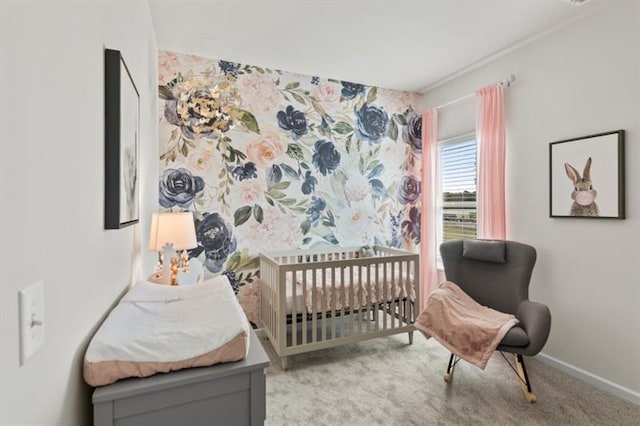 bedroom featuring light carpet, baseboards, and a crib